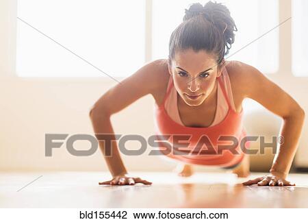 Close up of Hispanic woman doing push-ups in gym View Large Photo Image Stock Image - Close up of Hispanic woman doing push-ups in gym. Fotosearch