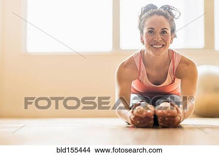 Close up of Hispanic woman stretching in gym View Large Photo Image Picture - Close up of Hispanic woman stretching in gym. Fotosearch