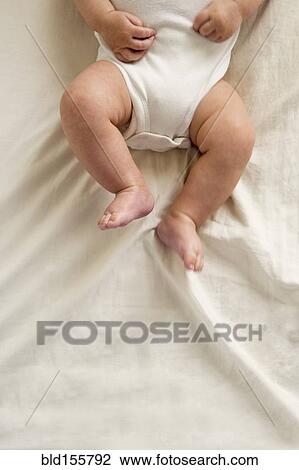 Stock Image - Close up of legs of mixed race baby boy. Fotosearch