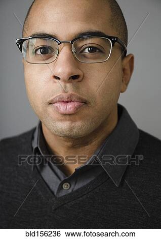 Close up of mixed race man wearing eyeglasses View Large Photo Image Stock Photograph - Close up of mixed race man wearing eyeglasses. Fotosearch