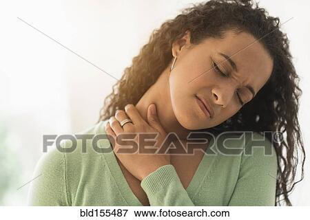 Close up of mixed race woman rubbing sore neck View Large Photo Image Stock Photo - Close up of mixed race woman rubbing sore neck. Fotosearch