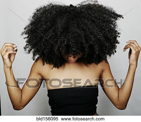 Close up of mixed race woman with curly hair looking down View Large Photo Image Stock Photography - Close up of mixed race woman with curly hair looking down. Fotosearch