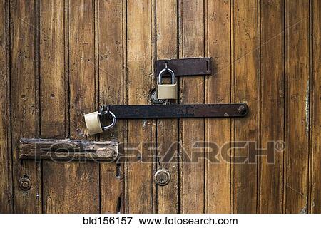 Close up of padlocks on secure door View Large Photo Image Stock Photo - Close up of padlocks on secure door. Fotosearch