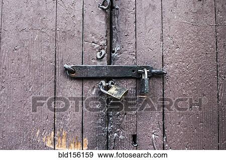 Stock Photo - Close up of padlocks on secure door. Fotosearch