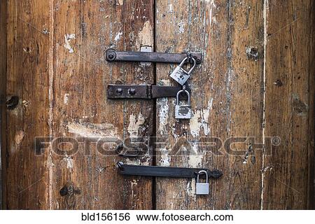 Close up of padlocks on secure door View Large Photo Image Stock Photograph - Close up of padlocks on secure door. Fotosearch