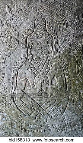 Stock Image - Close up of religious relief carving on wall. Fotosearch