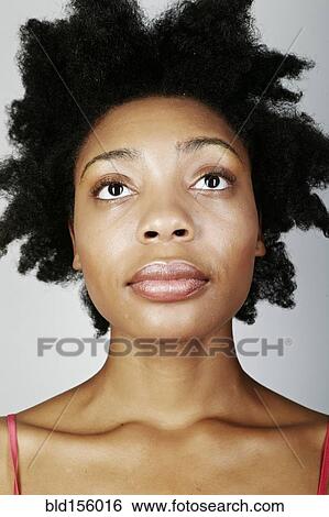 Close up of serious black woman looking up View Large Photo Image Stock Photograph - Close up of serious black woman looking up. Fotosearch