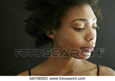 Close up of smiling black woman looking down View Large Photo Image Stock Image - Close up of smiling black woman looking down. Fotosearch