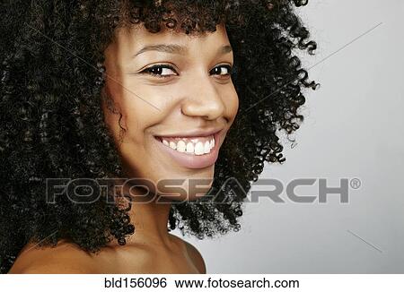 Stock Photograph - Close up of smiling face of mixed race woman. Fotosearch