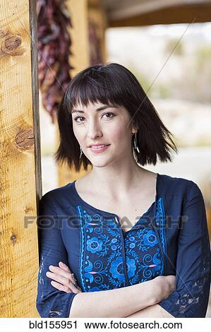 Close up of smiling Hispanic woman leaning on pillar View Large Photo Image Stock Image - Close up of smiling Hispanic woman leaning on pillar. Fotosearch
