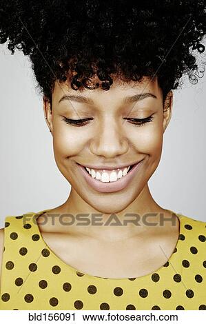 Close up of smiling mixed race woman looking down View Large Photo Image Stock Image - Close up of smiling mixed race woman looking down. Fotosearch