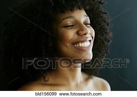 Close up of smiling mixed race woman with eyes closed View Large Photo Image Stock Photo - Close up of smiling mixed race woman with eyes closed. Fotosearch