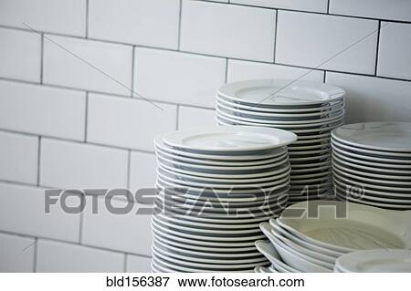 Stock Photo - Close up of stacked plates in restaurant kitchen. Fotosearch