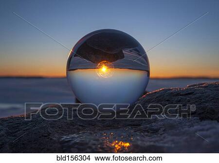Close up of sunset horizon inverted in glass sphere View Large Photo Image Picture - Close up of sunset horizon inverted in glass sphere. Fotosearch