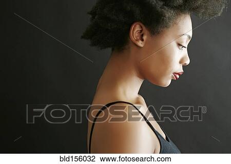 Stock Image - Close up profile of black woman looking down. Fotosearch