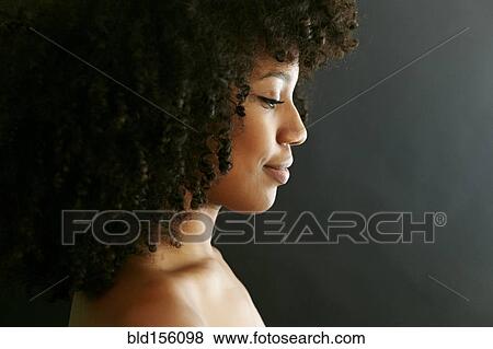 Stock Photo - Close up profile of smiling face of mixed race woman. Fotosearch