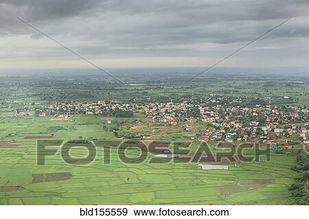 Stock Photo - Clouds over village in rural landscape. Fotosearch