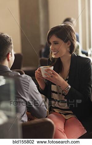 Stock Image - Couple drinking coffee in cafe. Fotosearch