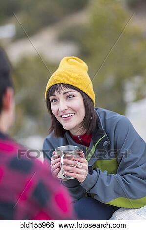 Stock Photograph - Couple drinking coffee outdoors. Fotosearch