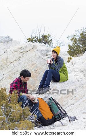 Couple sharing coffee on rock formations View Large Photo Image Stock Photo - Couple sharing coffee on rock formations. Fotosearch