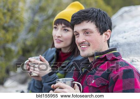 Couple sharing coffee on rock formations View Large Photo Image Stock Photography - Couple sharing coffee on rock formations. Fotosearch