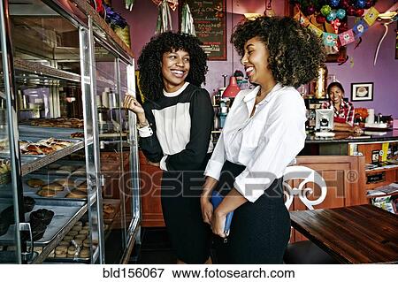 Customers buying pastries in bakery View Large Photo Image Stock Photo - Customers buying pastries in bakery. Fotosearch