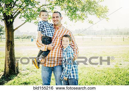 Father and sons smiling on farm View Large Photo Image Stock Photograph - Father and sons smiling on farm. Fotosearch