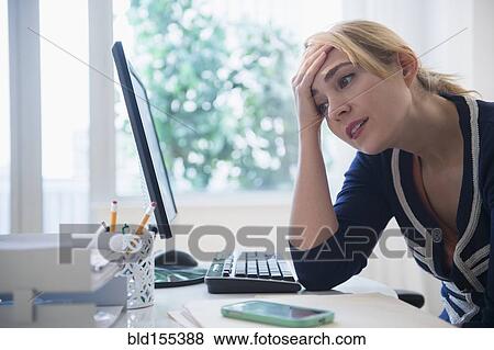 Stock Photo - Frustrated Caucasian businesswoman using computer. Fotosearch