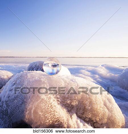 Glass sphere on frozen rock formations View Large Photo Image Stock Photograph - Glass sphere on frozen rock formations. Fotosearch