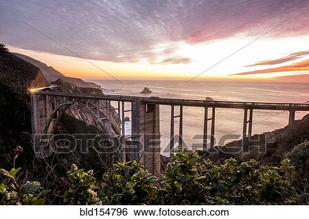 Stock Photograph - "High angle view of Bixby Bridge and sunset sky, Big Sur, California, United States". Fotosearch