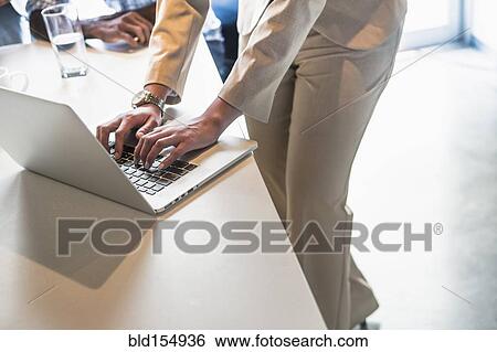 High angle view of businesswoman using laptop in office View Large Photo Image Stock Photograph - High angle view of businesswoman using laptop in office. Fotosearch