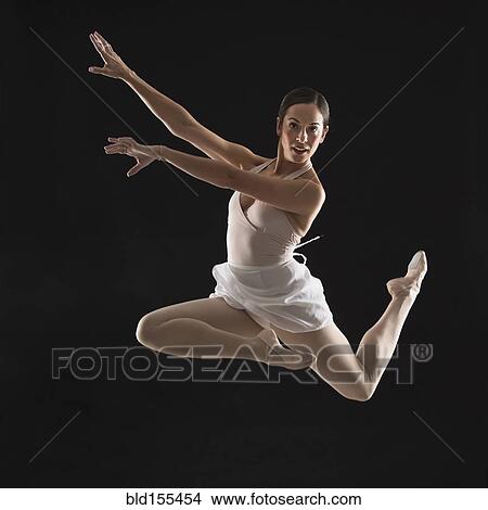 Picture - Hispanic ballet dancer leaping in mid-air. Fotosearch