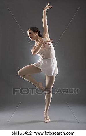 Stock Image - Hispanic ballet dancer posing on tip toe. Fotosearch