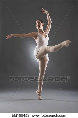 Stock Image - Hispanic ballet dancer posing on tip toe. Fotosearch