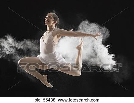 Stock Photo - Hispanic dancer leaping in cloud. Fotosearch