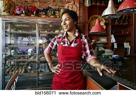 Hispanic waitress smiling in bakery View Large Photo Image Stock Image - Hispanic waitress smiling in bakery. Fotosearch