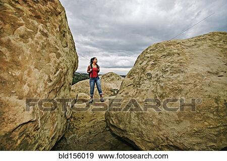 Hispanic woman hiking on rock formations View Large Photo Image Stock Photo - Hispanic woman hiking on rock formations. Fotosearch