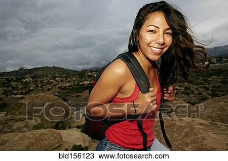 Hispanic woman smiling on rock formation View Large Photo Image Stock Image - Hispanic woman smiling on rock formation. Fotosearch