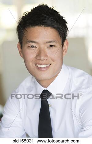 Stock Image - Korean businessman smiling. Fotosearch