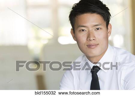 Stock Image - Korean businessman smiling. Fotosearch