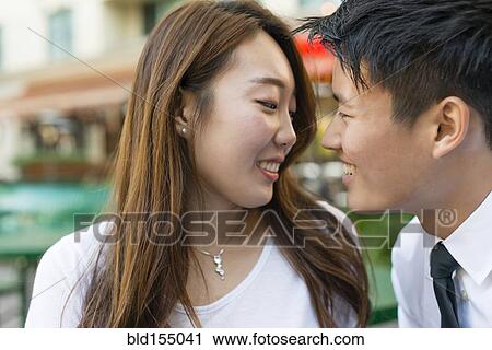 Korean couple smiling at sidewalk cafe View Large Photo Image Stock Image - Korean couple smiling at sidewalk cafe. Fotosearch