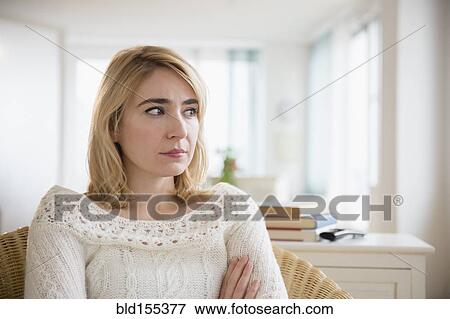 Lonely Caucasian woman sitting in living room View Large Photo Image Stock Photo - Lonely Caucasian woman sitting in living room. Fotosearch