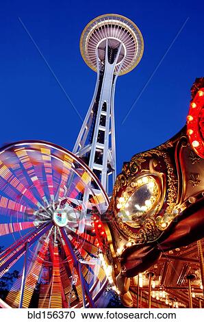 Stock Image - "Low angle view of Space Needle, ferris wheel and carousel under night sky, Seattle, Washington, United States". Fotosearch