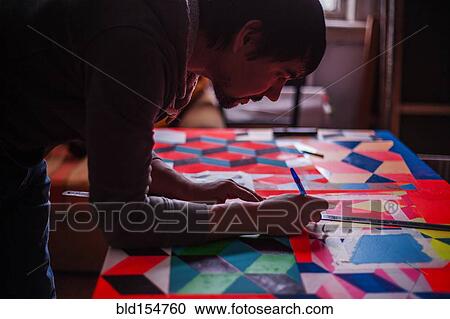 Mari man designing colorful table View Large Photo Image Stock Image - Mari man designing colorful table. Fotosearch