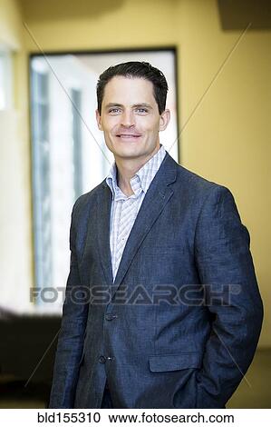 Mixed race businessman smiling in office View Large Photo Image Stock Image - Mixed race businessman smiling in office. Fotosearch