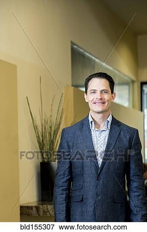 Stock Photo - Mixed race businessman smiling in office. Fotosearch