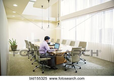 Mixed race businessman working on laptop in conference room View Large Photo Image Stock Photography - Mixed race businessman working on laptop in conference room. Fotosearch