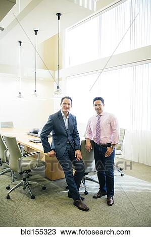 Mixed race businessmen smiling in office meeting View Large Photo Image Stock Image - Mixed race businessmen smiling in office meeting. Fotosearch