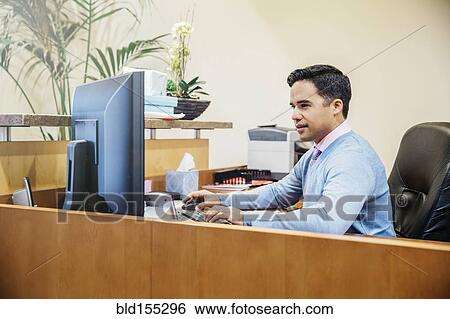 Mixed race secretary working in office lobby View Large Photo Image Stock Photograph - Mixed race secretary working in office lobby. Fotosearch
