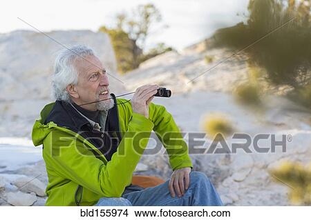 Older man admiring view with binoculars View Large Photo Image Picture - Older man admiring view with binoculars. Fotosearch